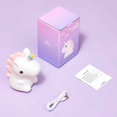 Unicorn-shaped night light with packaging, USB cable, and instruction sheet on a purple background